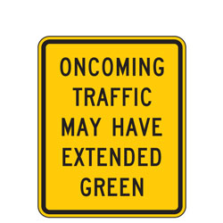 Oncoming Traffic May Have Extended Green Warning Signs